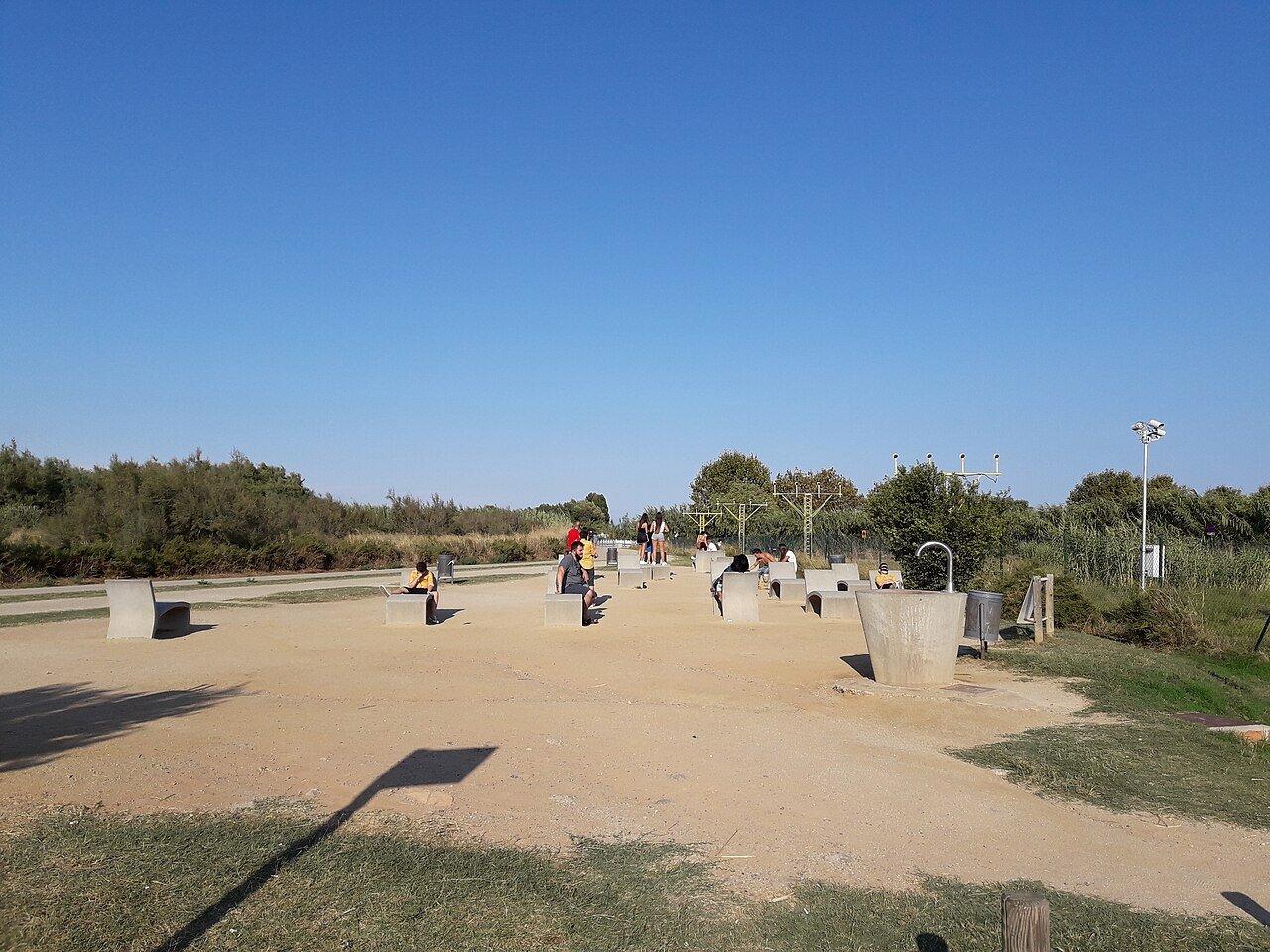 Visitors and a cyclist at the aircraft viewpoint outside El Prat