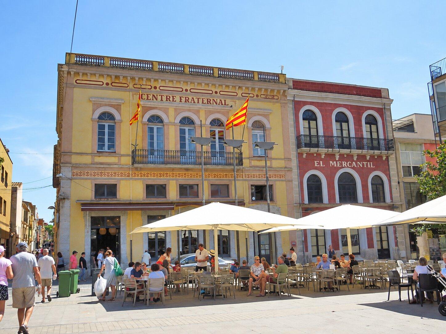 Café terraces in front of the Centre Fraternal and Cercle Mercantil in Palafrugell